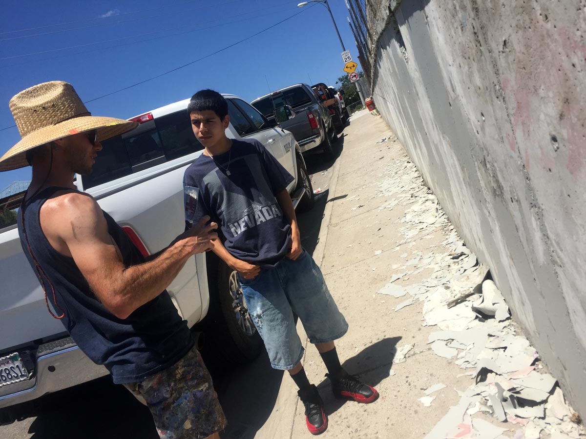 Neighborhood teenager talking with Erik about the mural: Heirloom