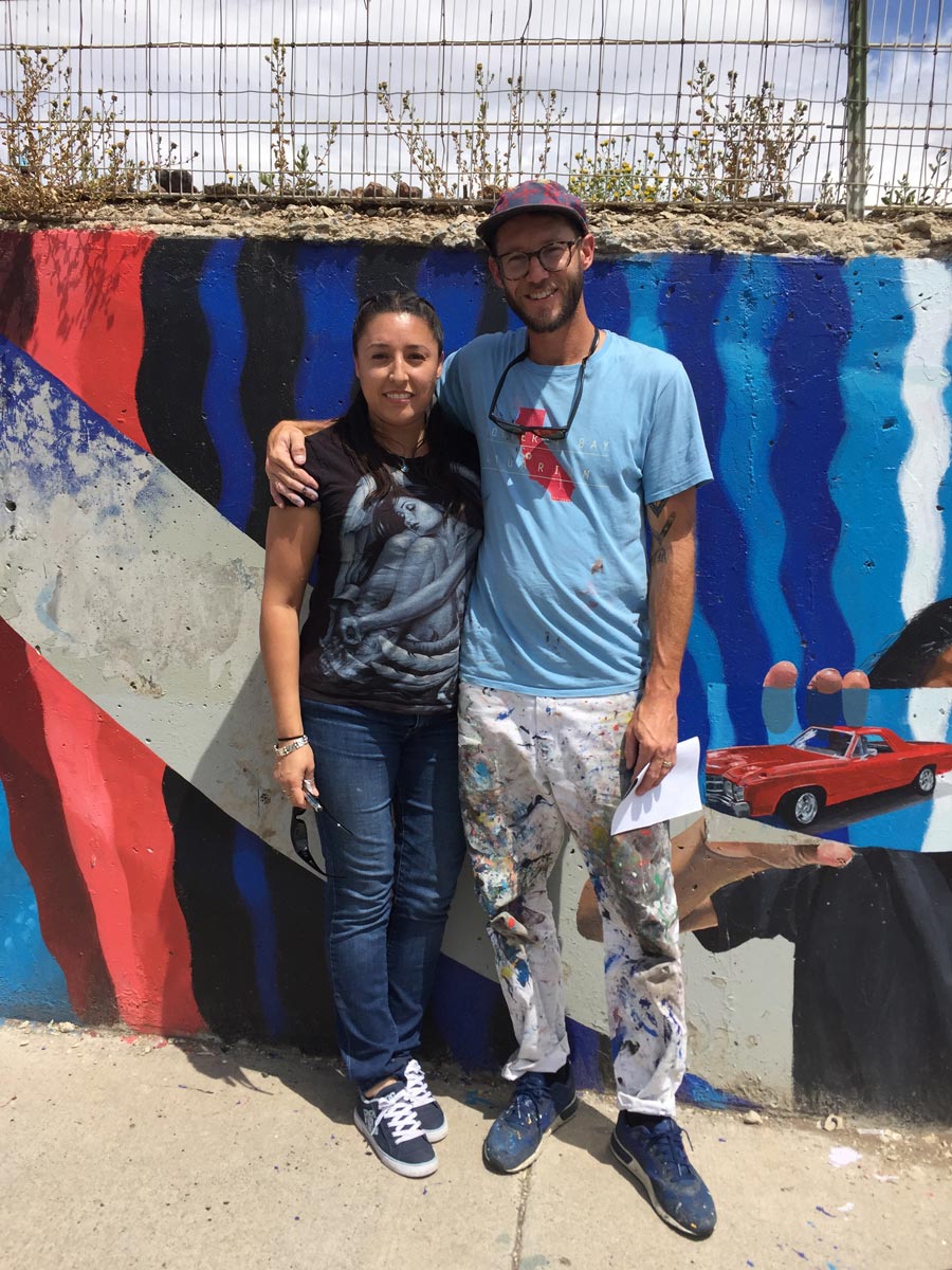 A woman from the neighborhood next to the artist Erik Burke