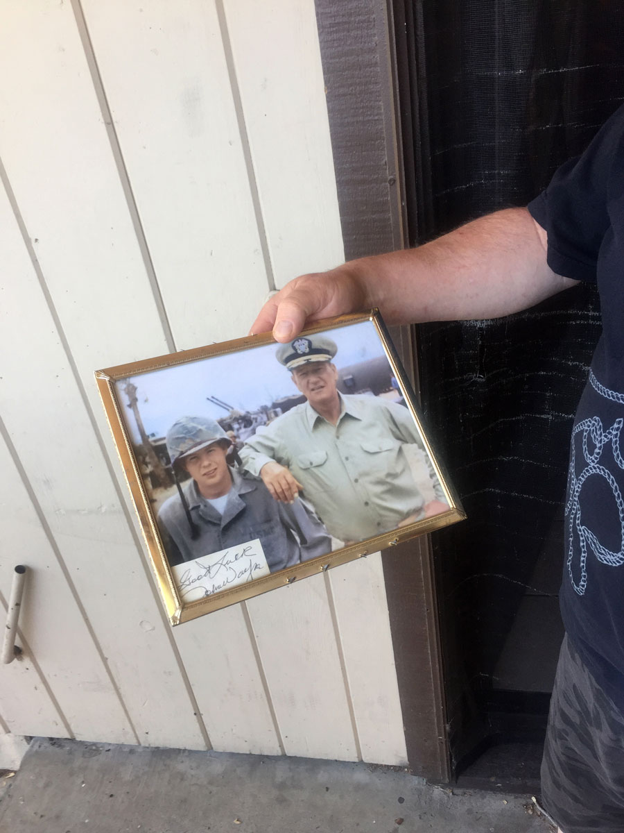 Photo of a neighbor's father while in the Service, overseas on duty, with John Wayne